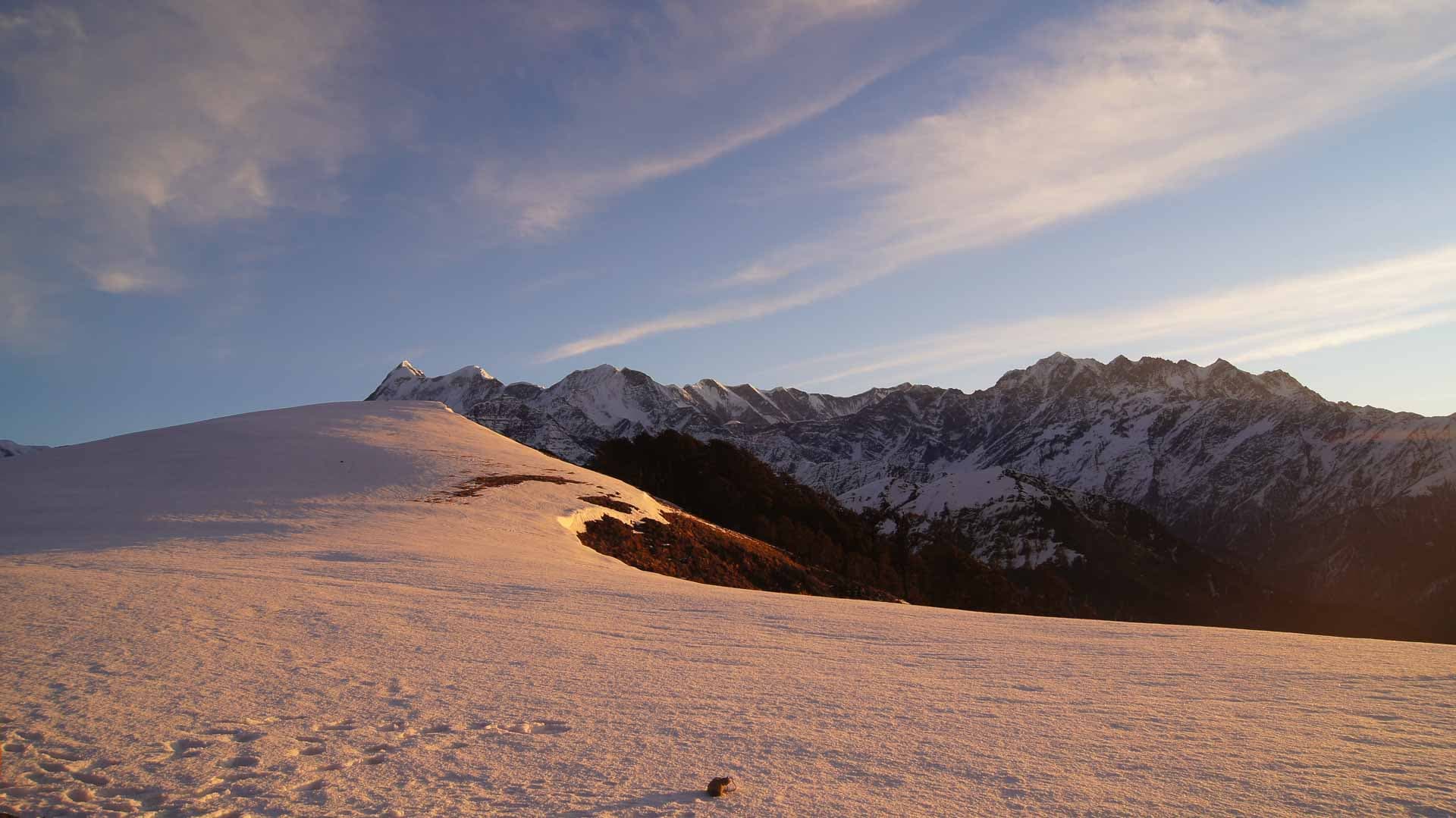 Golden sunlight shining on snowcapped mountains