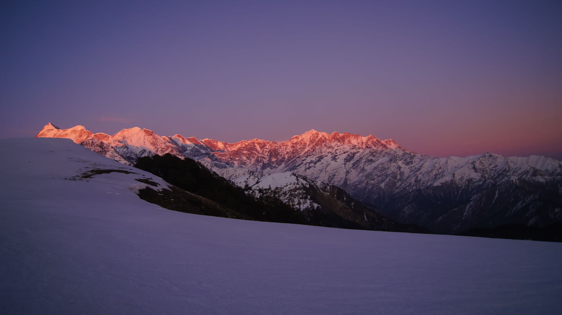 Orange sunlight crowning distant mountains