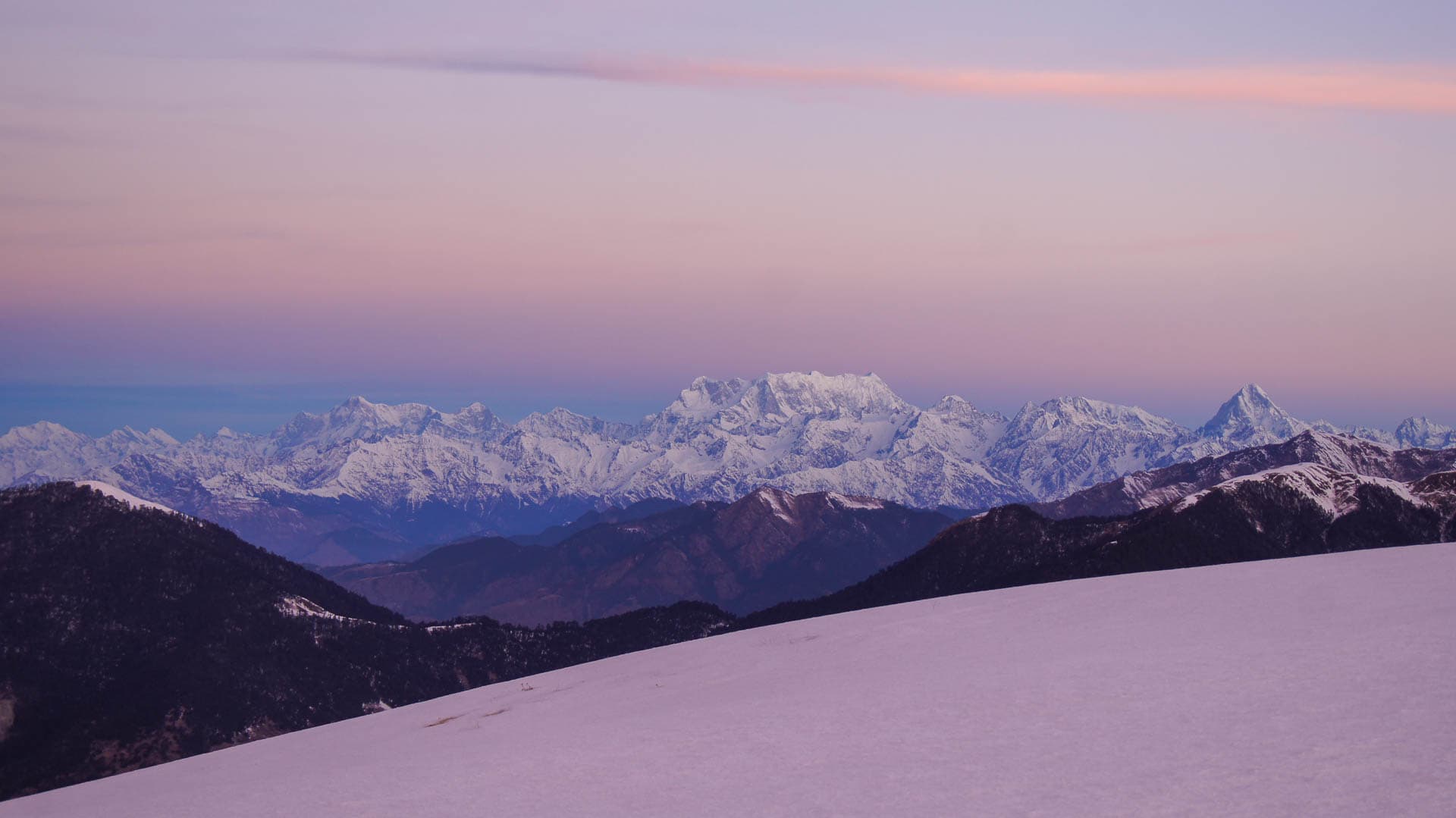 Snow capped mountains at sunset