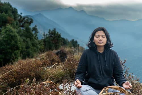 A person sat in a meditative pose