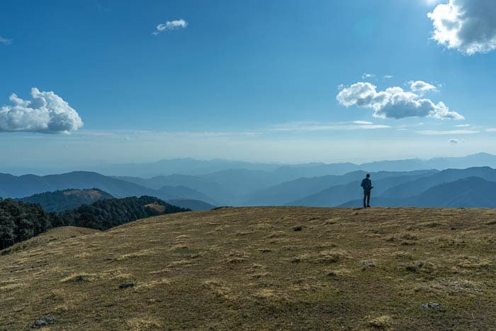 One person standing on the horizon of a mountain