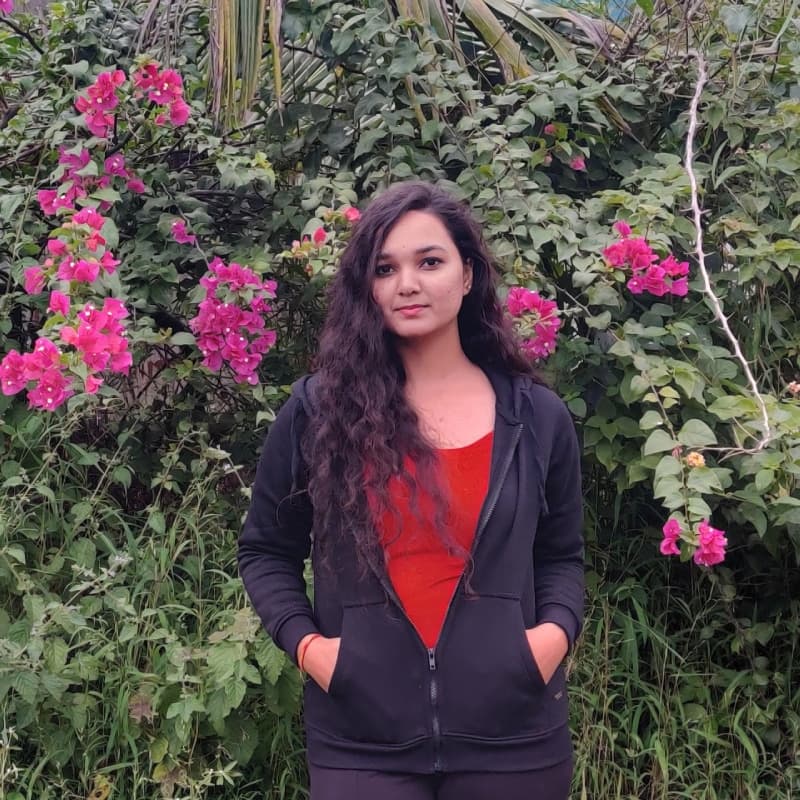 Sikha standing in front of some flowers